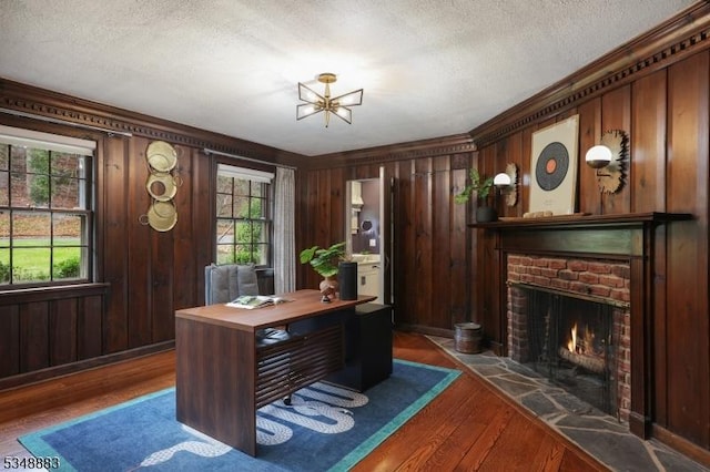 office featuring a textured ceiling, a healthy amount of sunlight, and hardwood / wood-style floors