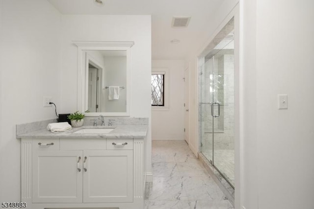 full bathroom with vanity, marble finish floor, baseboards, visible vents, and a stall shower