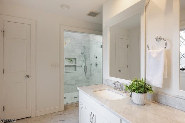 full bathroom with vanity, marble finish floor, baseboards, a shower stall, and visible vents