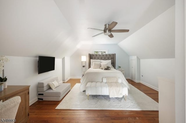 bedroom with a ceiling fan, baseboards, vaulted ceiling, and wood finished floors