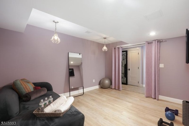 interior space featuring baseboards, visible vents, and light wood-style floors
