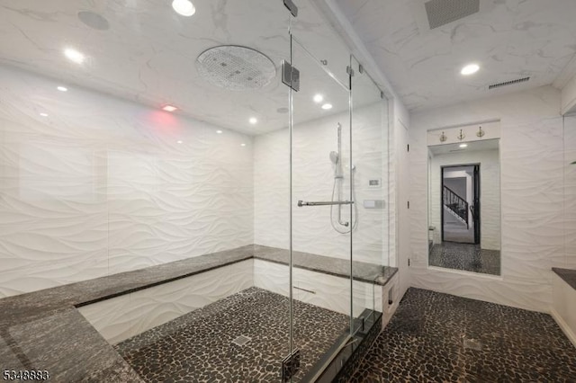 full bathroom featuring a marble finish shower, recessed lighting, and visible vents