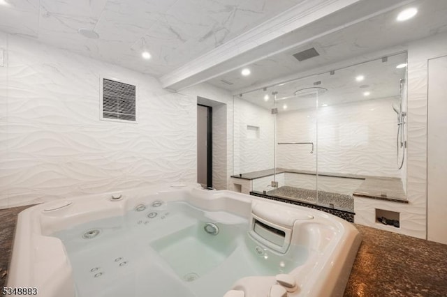 bathroom with a walk in shower, a whirlpool tub, and visible vents