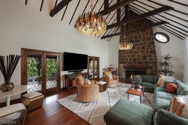 living area featuring a notable chandelier, a fireplace, high vaulted ceiling, french doors, and wood finished floors