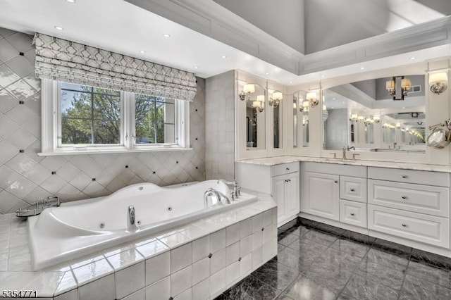 bathroom with vanity, marble finish floor, a whirlpool tub, recessed lighting, and a chandelier