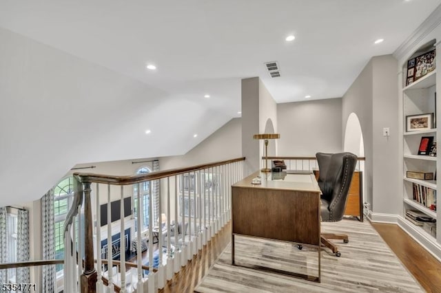 office space featuring arched walkways, recessed lighting, baseboards, wood finished floors, and visible vents