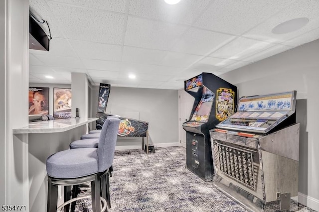 game room with baseboards, a paneled ceiling, and carpet floors