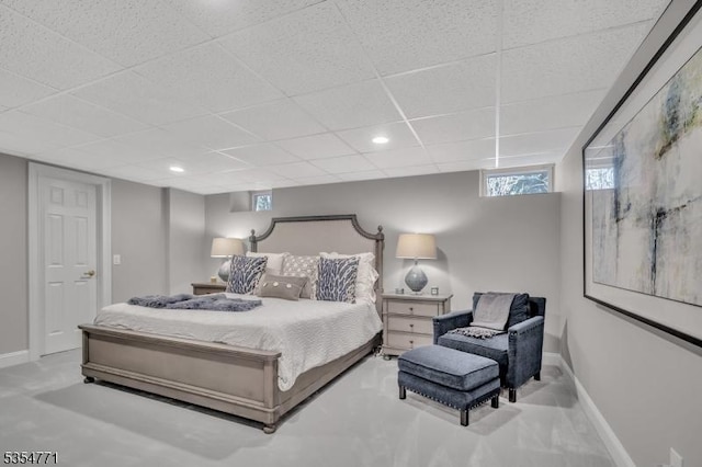 bedroom featuring baseboards and a paneled ceiling