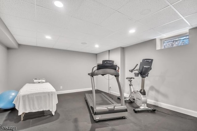 workout room with baseboards, recessed lighting, and a drop ceiling