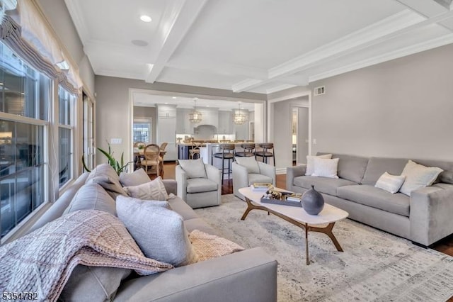 living area with ornamental molding, coffered ceiling, beam ceiling, and visible vents