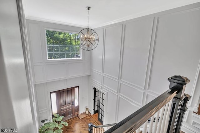 foyer featuring a decorative wall and a notable chandelier