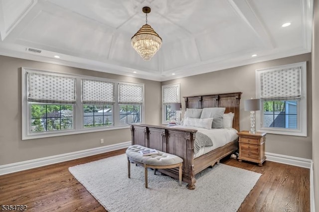bedroom with recessed lighting, baseboards, wood finished floors, and a notable chandelier