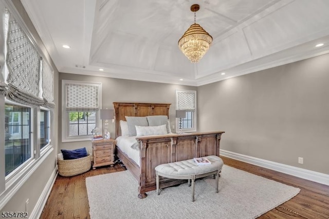 bedroom featuring baseboards, a notable chandelier, ornamental molding, and wood finished floors