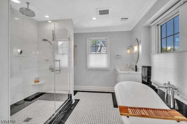 bathroom featuring a freestanding tub, visible vents, baseboards, and a stall shower