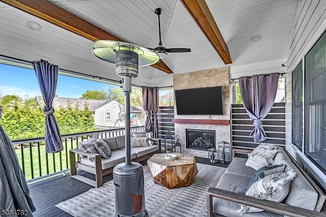 exterior space with an outdoor living space with a fireplace and a wooden deck