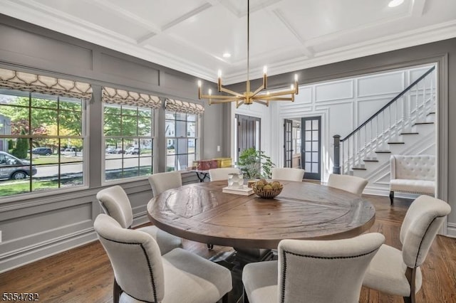 dining area with stairway, coffered ceiling, and a decorative wall