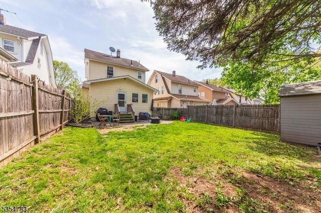 back of property featuring entry steps, a yard, a fenced backyard, and a patio area