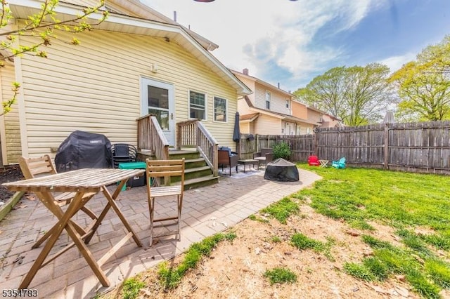 back of property featuring a fenced backyard, a patio, and a yard