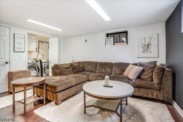 living area featuring independent washer and dryer and wood finished floors