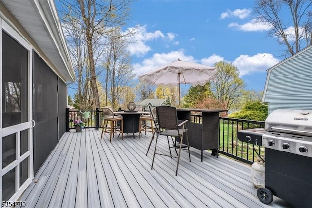 wooden terrace featuring outdoor dry bar and area for grilling