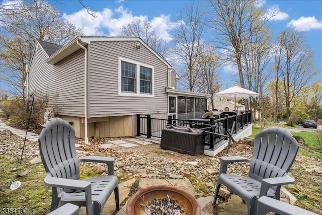 rear view of property with a sunroom