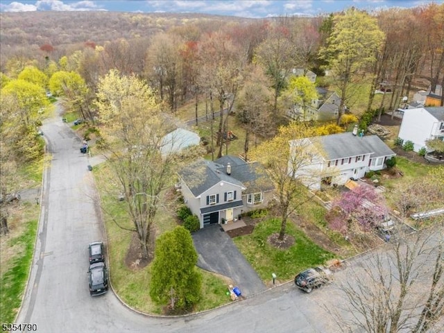 drone / aerial view featuring a view of trees