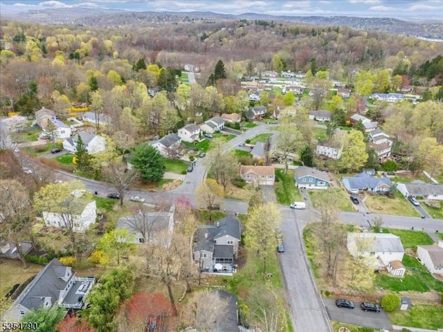 birds eye view of property with a residential view and a wooded view