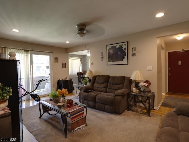 living room with light wood-type flooring, baseboards, a ceiling fan, and recessed lighting