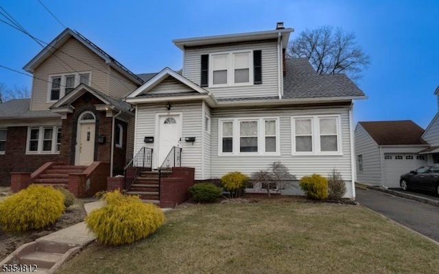 view of front of house with roof with shingles and a front lawn