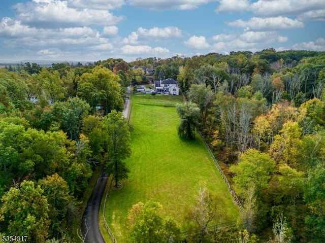 birds eye view of property with a wooded view