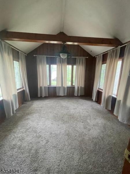 218 Wawayanda Rd, Vernon Twp, NJ 07422 - carpeted empty room featuring vaulted ceiling with beams and a wealth of natural light