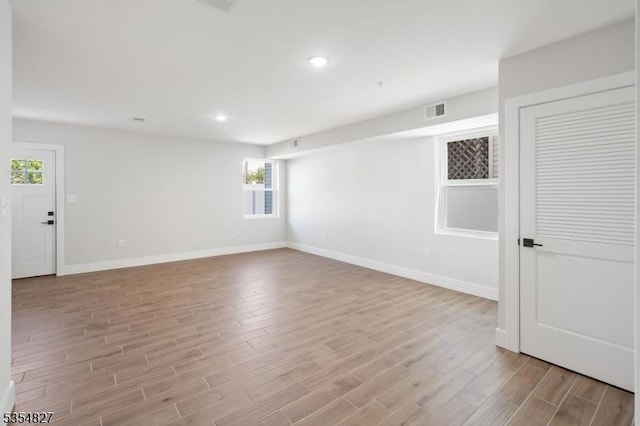 unfurnished room featuring visible vents, recessed lighting, baseboards, and wood finished floors