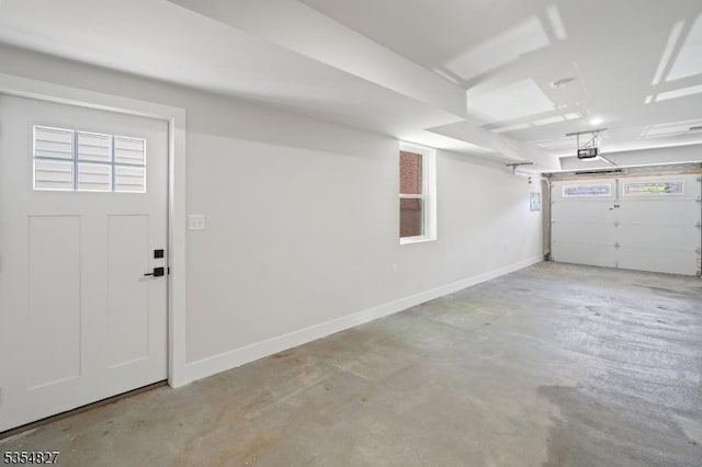 garage with baseboards and a garage door opener