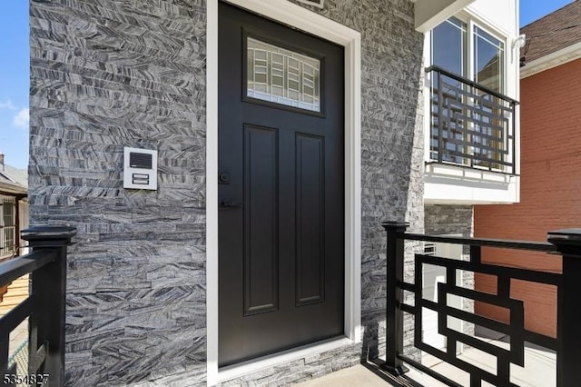 view of exterior entry featuring stone siding