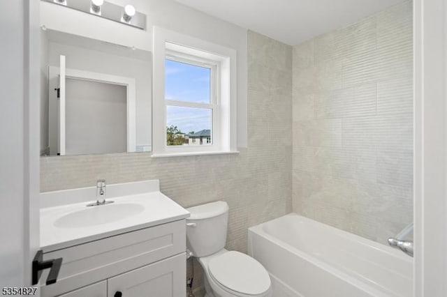 full bathroom with tile walls, tasteful backsplash, vanity, toilet, and tub / shower combination