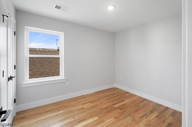unfurnished room featuring visible vents, recessed lighting, light wood-style floors, and baseboards