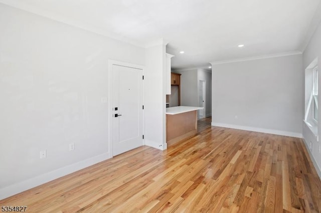 unfurnished living room featuring crown molding, recessed lighting, light wood-style flooring, and baseboards
