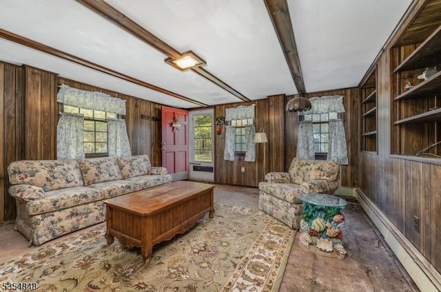 living area featuring plenty of natural light, a baseboard heating unit, and wood walls