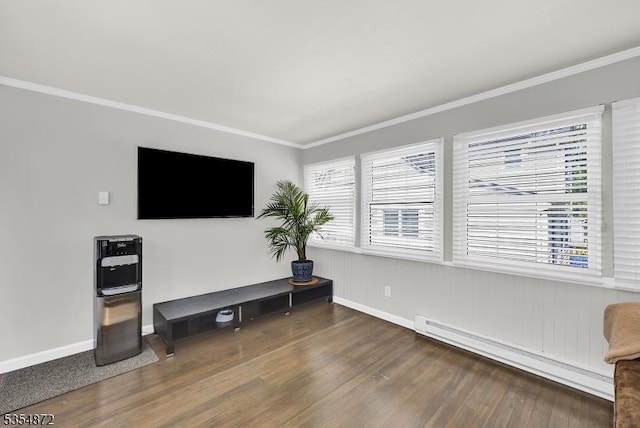 living room featuring a baseboard radiator, baseboards, wood finished floors, and crown molding