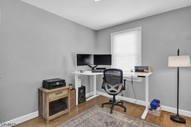 office space with wood finished floors and baseboards