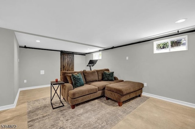 living area featuring recessed lighting, baseboards, and a barn door
