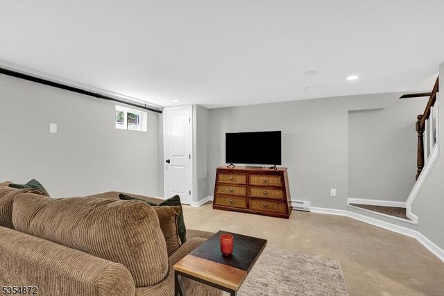 living area with a baseboard heating unit, baseboards, light colored carpet, and recessed lighting