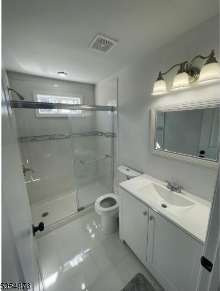 full bathroom with visible vents, tile patterned flooring, a stall shower, vanity, and toilet