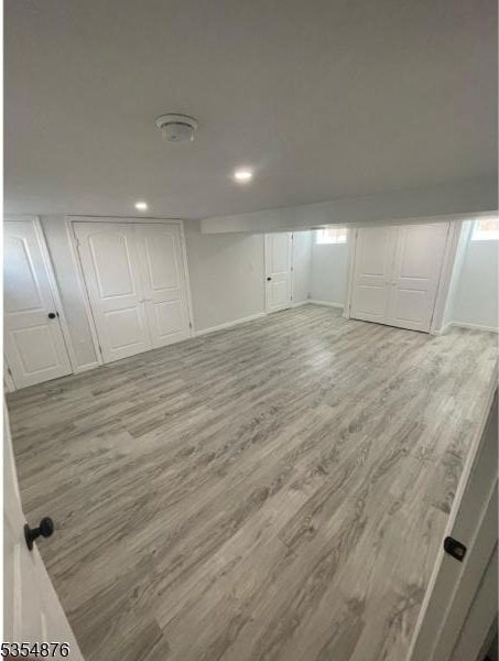 unfurnished bedroom with recessed lighting, baseboards, wood finished floors, and a closet