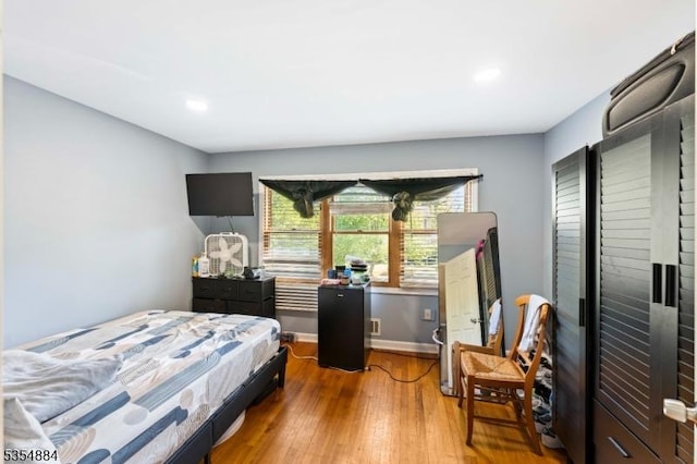 bedroom with recessed lighting, baseboards, and hardwood / wood-style floors