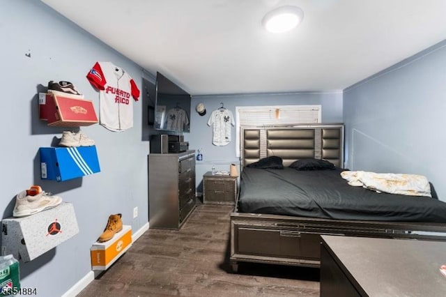 bedroom featuring dark wood-style flooring and baseboards