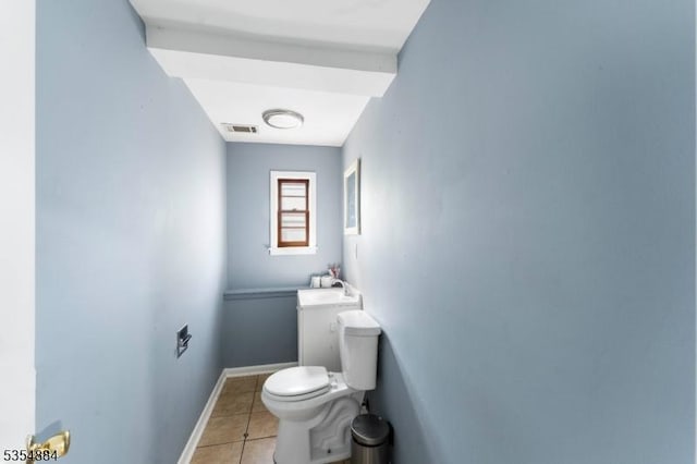 bathroom with baseboards, tile patterned flooring, toilet, and visible vents