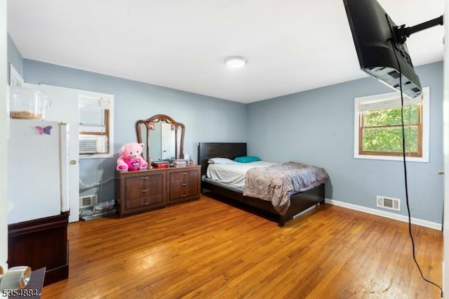 bedroom featuring baseboards, visible vents, and light wood-type flooring