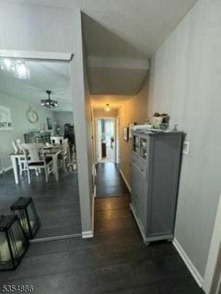 1301 Spruce Hills Dr, Glen Gardner Boro, NJ 08826 - hallway featuring baseboards, vaulted ceiling, and dark wood-type flooring