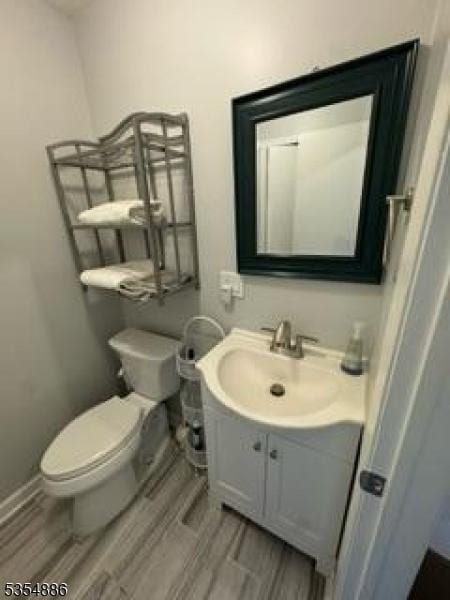 1301 Spruce Hills Dr, Glen Gardner Boro, NJ 08826 - half bath featuring toilet, wood finished floors, and vanity